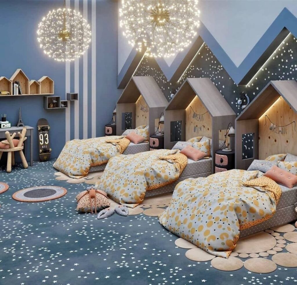 Kids room with house bed frames large light fixtures and star pattern carpet in blue tones