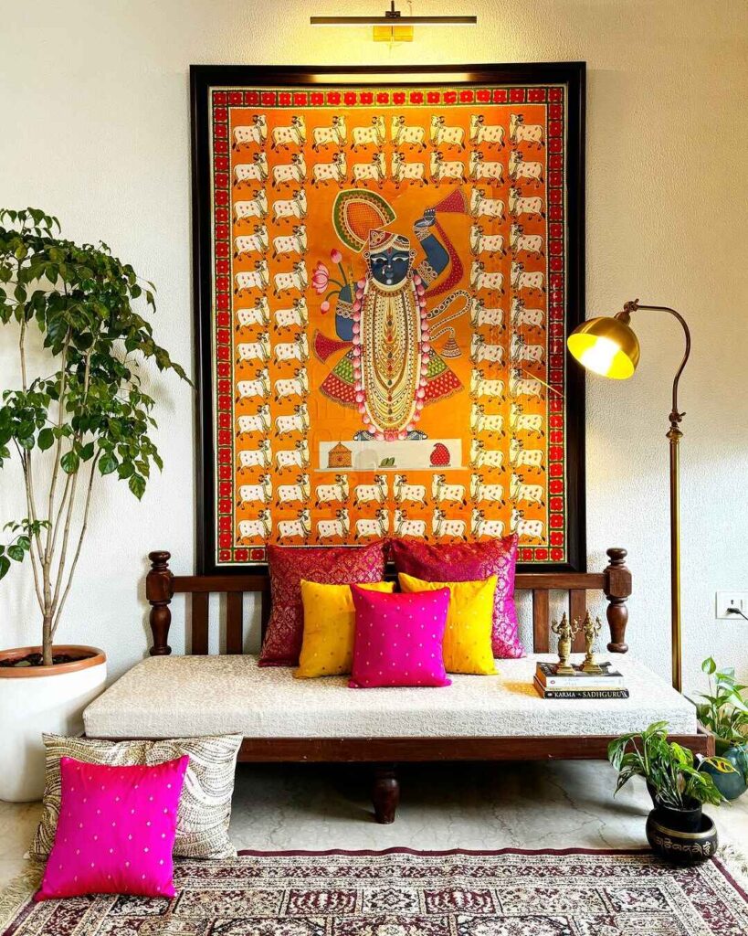 Traditional Indian daybed with colorful artwork display and decorative cushions