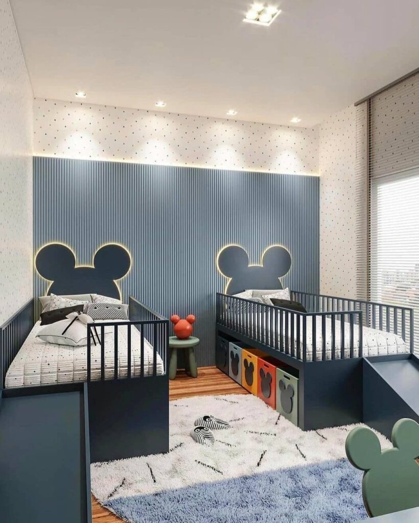 Contemporary kids bedroom with Mickey Mouse themed headboards and navy blue striped walls