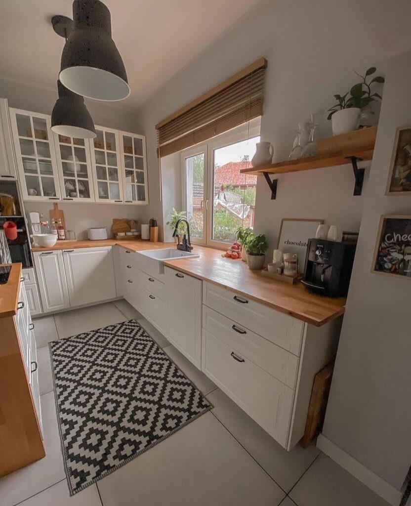 White L-shaped kitchen with geometric rug and glass cabinets