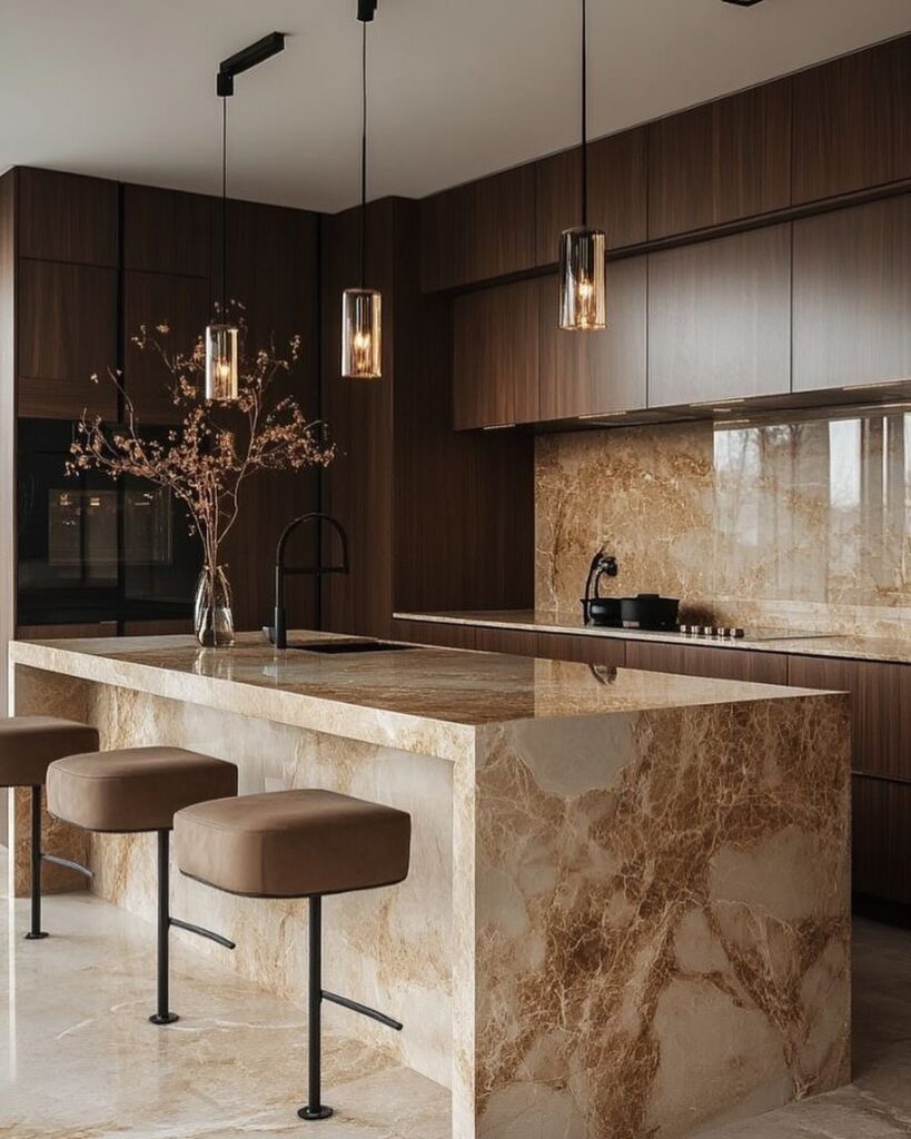 Brown kitchen with beige stone island and glass pendant lights