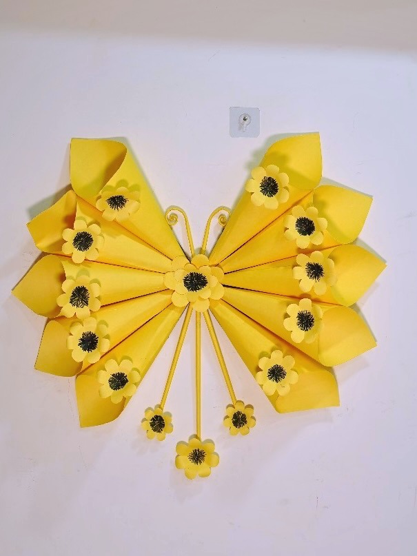 Yellow paper butterfly wall art decorated with dimensional flowers