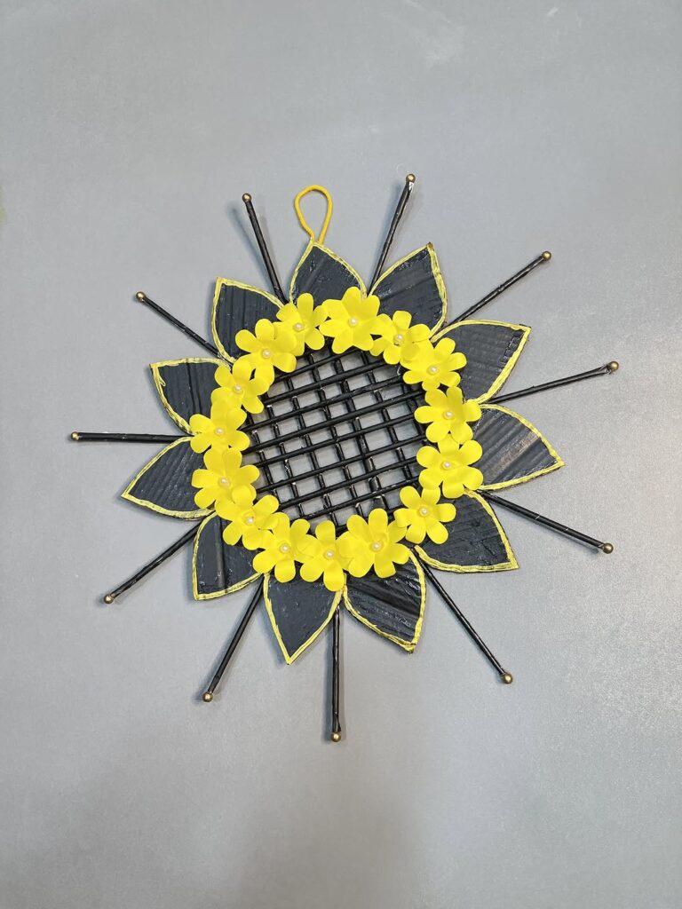 Black and yellow paper sunflower wreath with geometric details