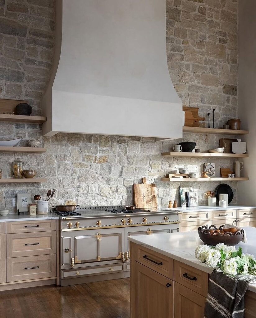 Kitchen with stone walls white hood and wooden shelving