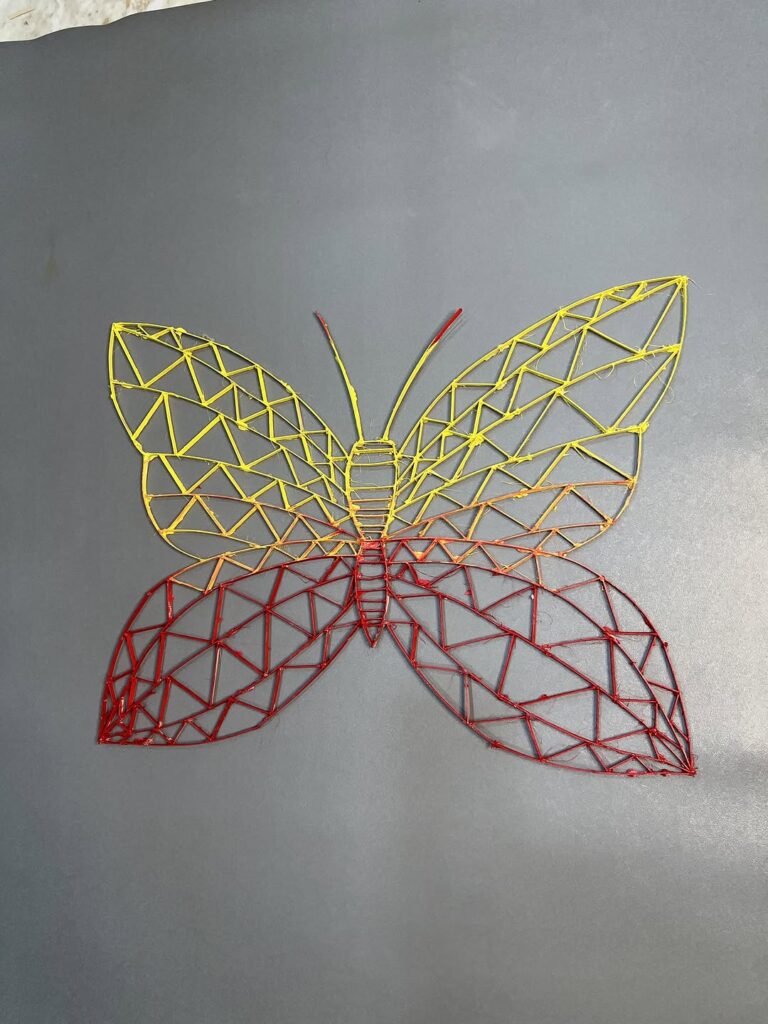 Wire butterfly wall art in geometric pattern with yellow and red gradient