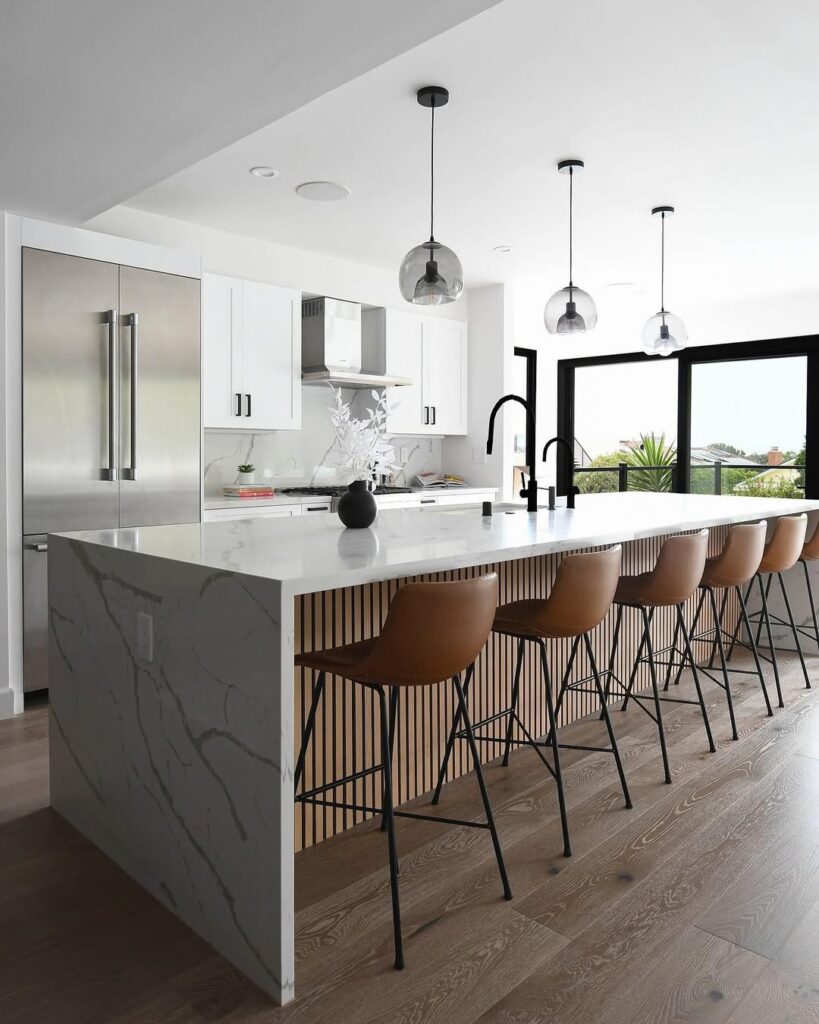 Modern kitchen with marble island wood details and leather stools