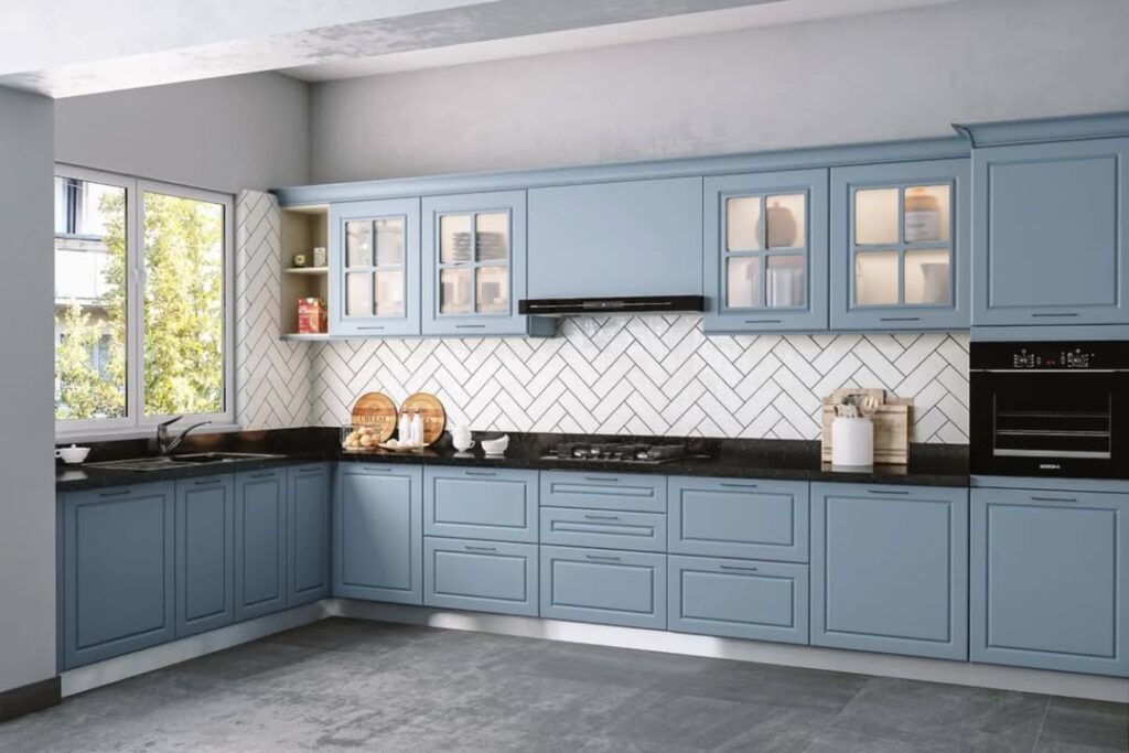 Blue kitchen with herringbone backsplash glass cabinets and black counters