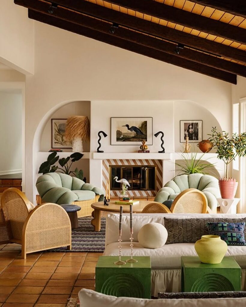 Spanish style living room with mint chairs arched fireplace and rattan furniture