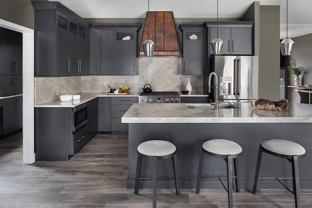 Elegant grey kitchen with copper hood and marble countertops featuring modern bar stools