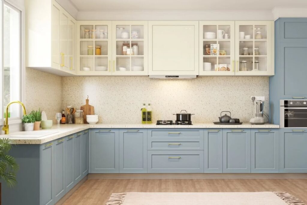 Light blue and cream kitchen with brass hardware and speckled countertops