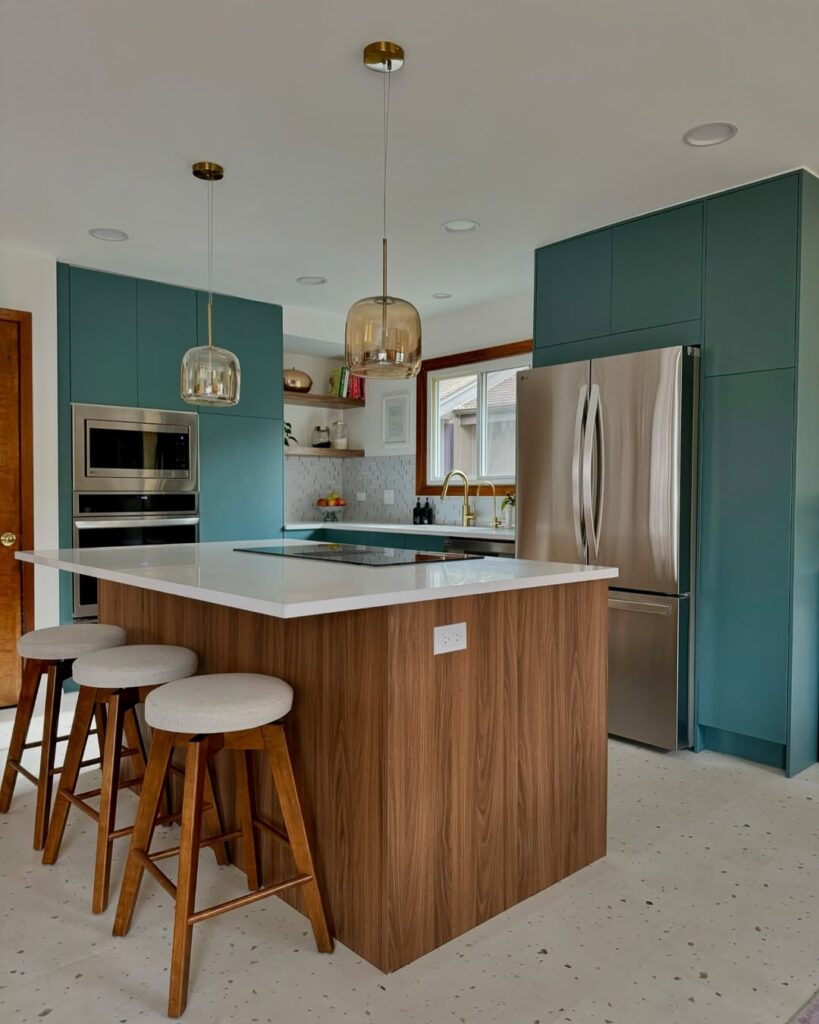 Modern kitchen with teal cabinets and walnut island