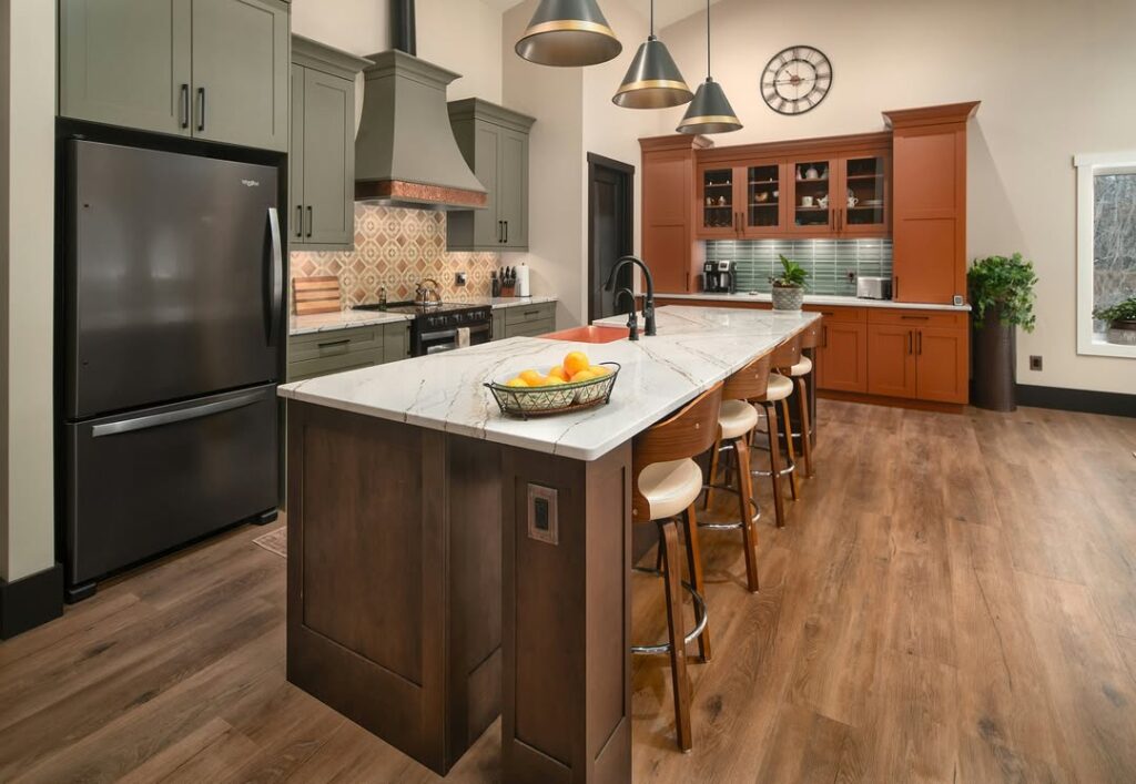 Kitchen with sage cabinets and geometric tile backsplash