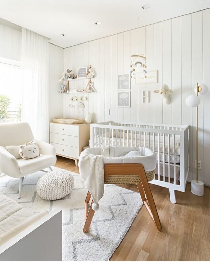 All white nursery with modern furniture wooden accents and geometric wall shelves