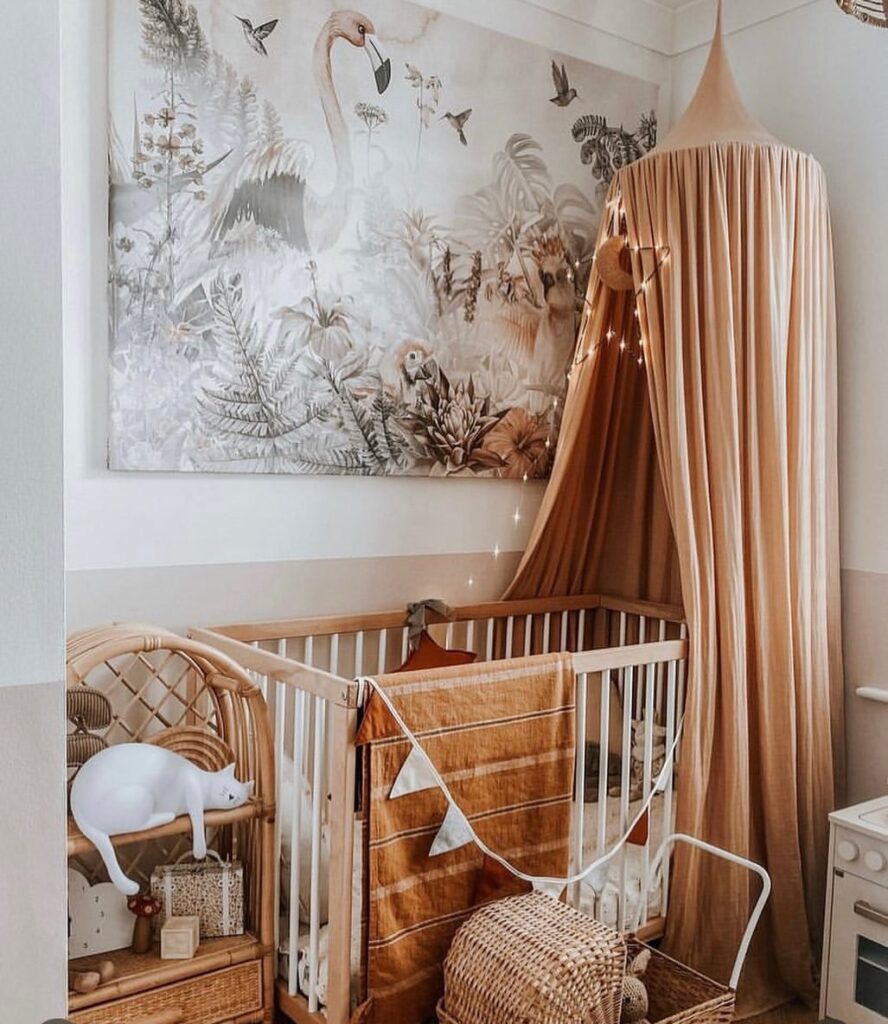 Nursery with tropical mural honey colored canopy and white crib