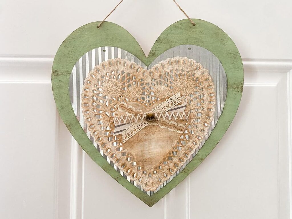 Heart shaped wall decor with lace doily and green wooden frame