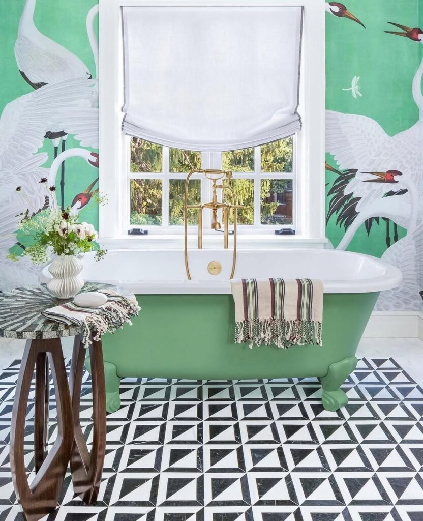 Green bathroom with crane wallpaper and geometric tiles