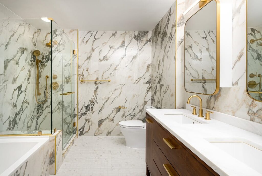  Modern bathroom with marble walls and gold accents