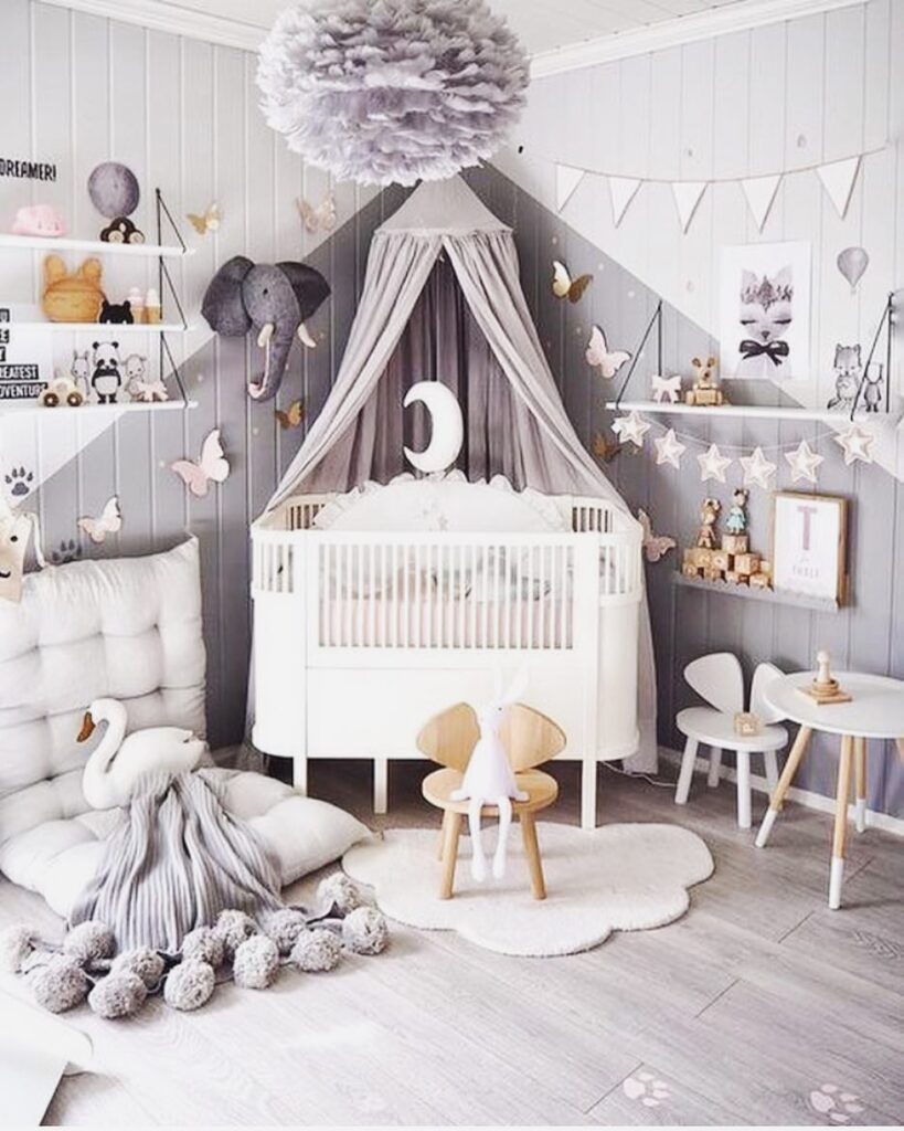 Gray nursery with white crib canopy butterfly decor and cloud shaped rug