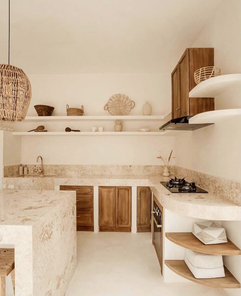 Stone kitchen with wooden cabinets and woven pendant lighting