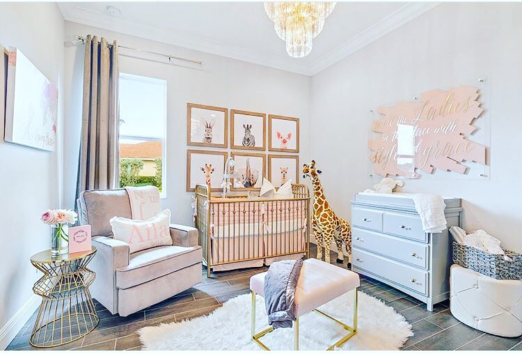  Luxe nursery with safari artwork gold crib and crystal chandelier