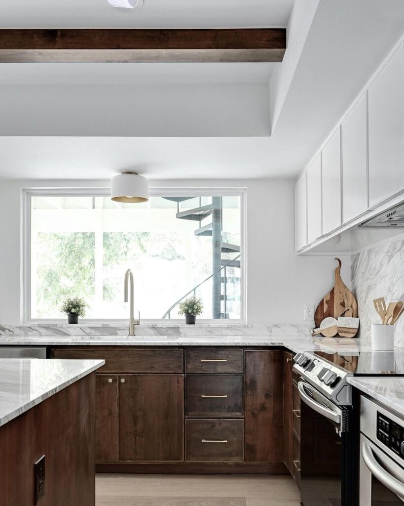 Kitchen with walnut cabinets marble counters and wooden beams