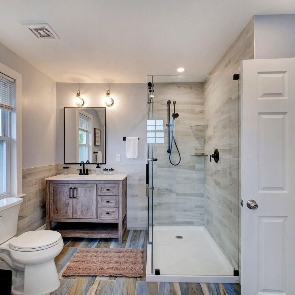 Modern bathroom with wood vanity and glass shower enclosure