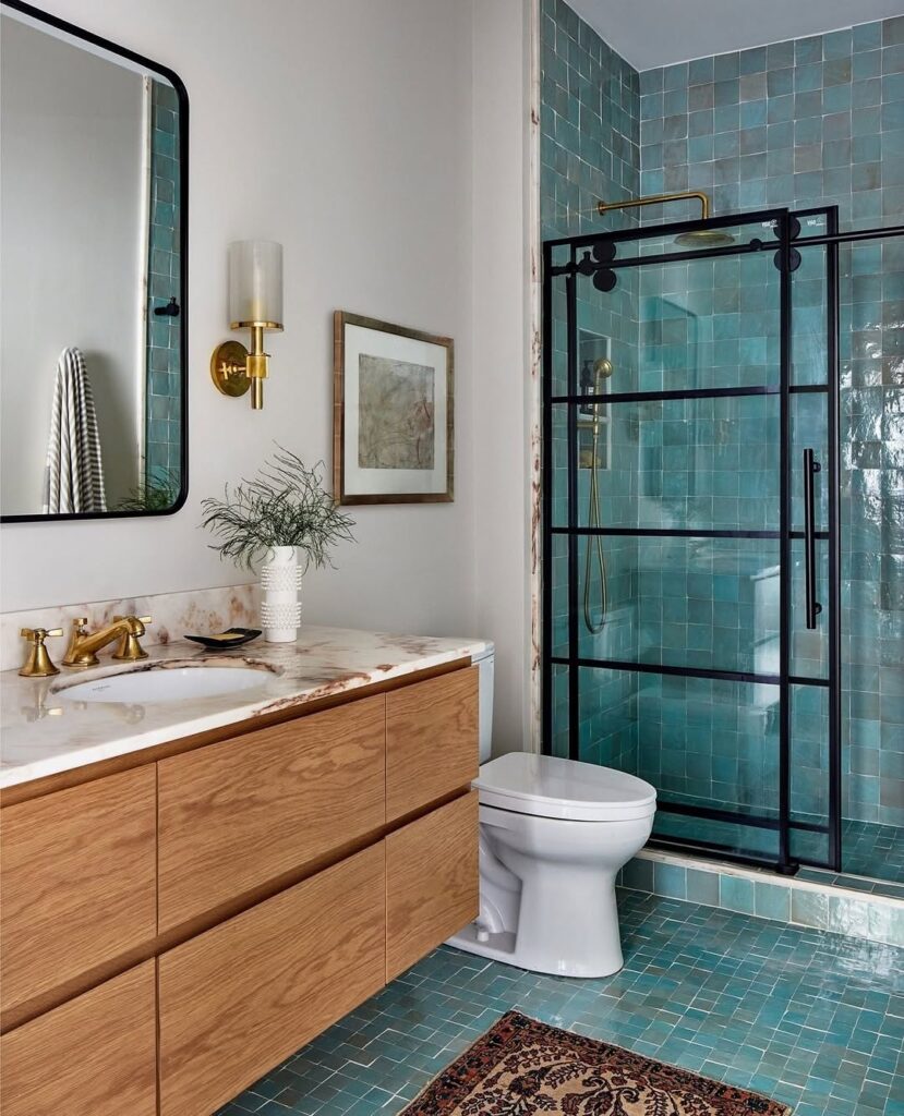 Modern bathroom with aqua tiles and black shower frame