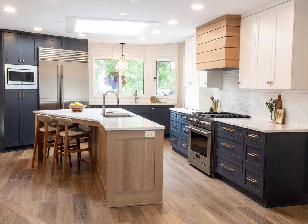 Kitchen with navy cabinets white tile and wood acce