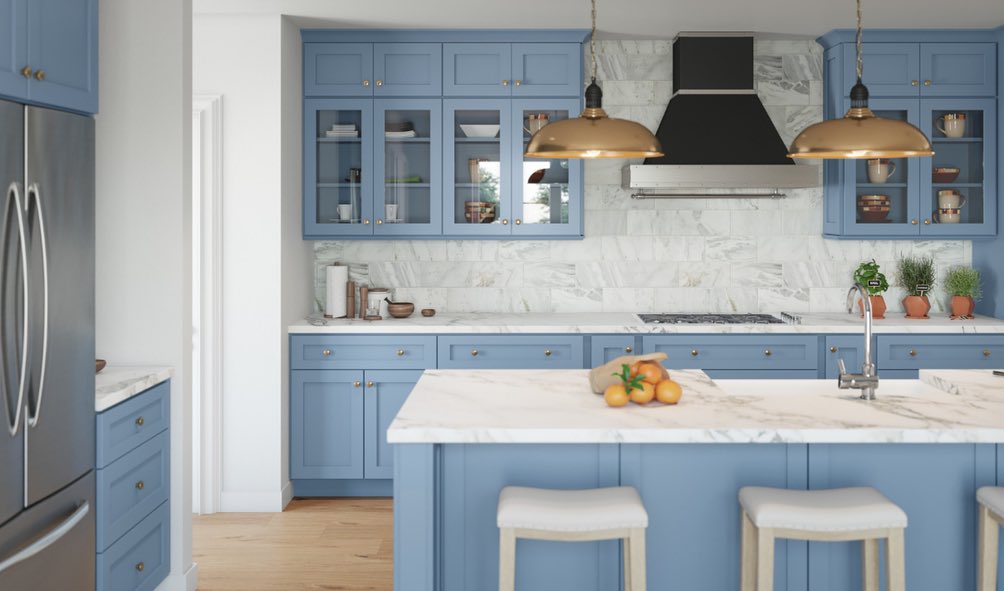 Light blue kitchen with brass pendants marble backsplash and white countertops