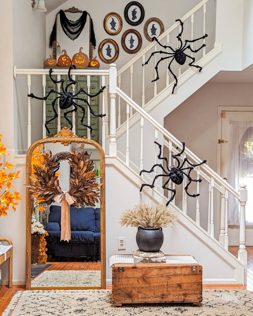 Halloween decorated stairway with spiders mirrors and autumn wreath