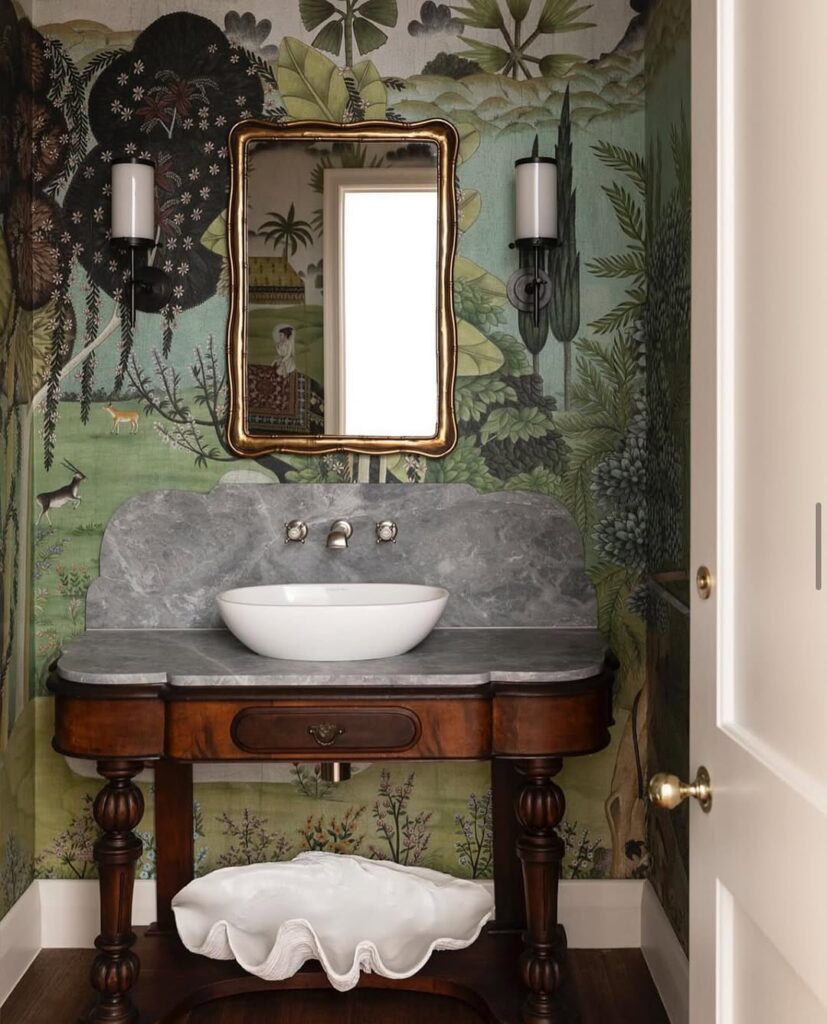 Powder room with scenic wallpaper and antique vanity