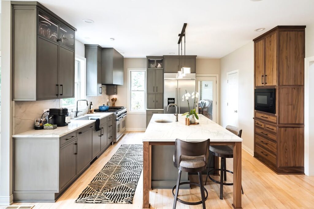 Modern galley kitchen with gray cabinets and walnut details