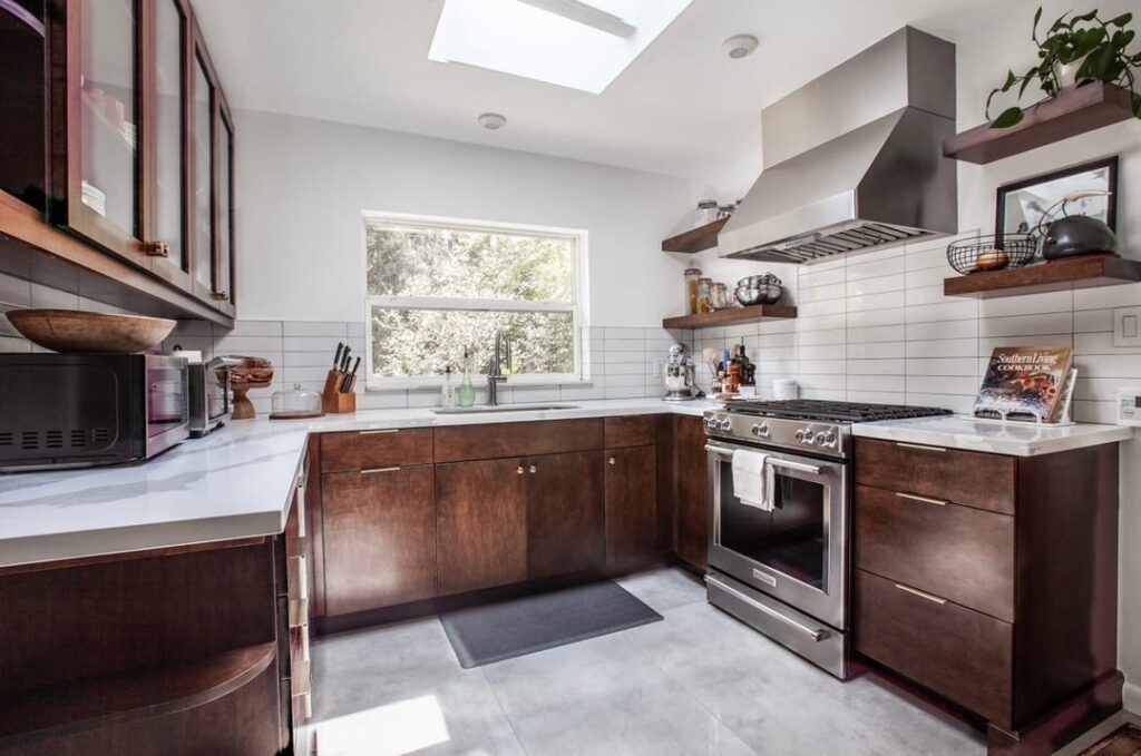 Modern kitchen with dark cabinets and concrete floors