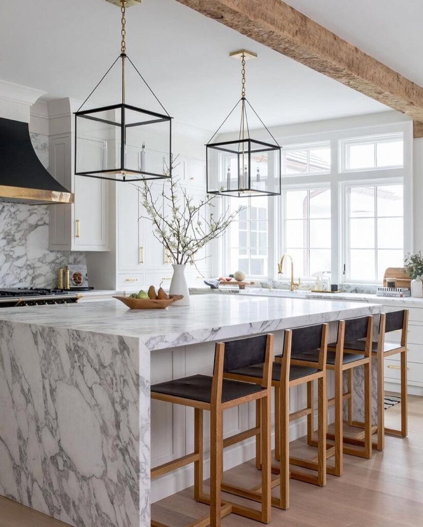 Modern kitchen with marble waterfall island and black lantern pendants