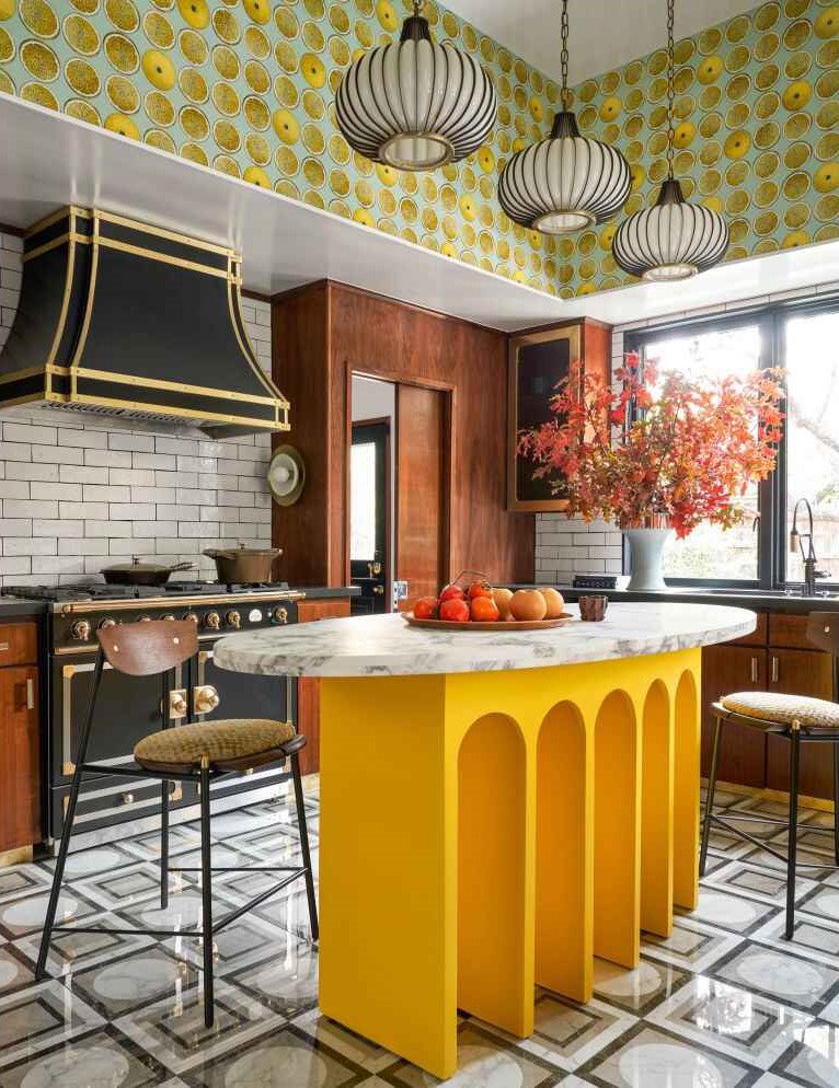 Kitchen with yellow arched island marble top and citrus wallpaper