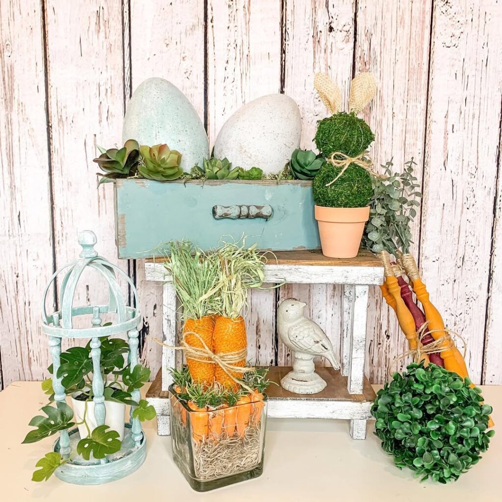 Easter themed display with aqua drawer speckled eggs and decorative carrots