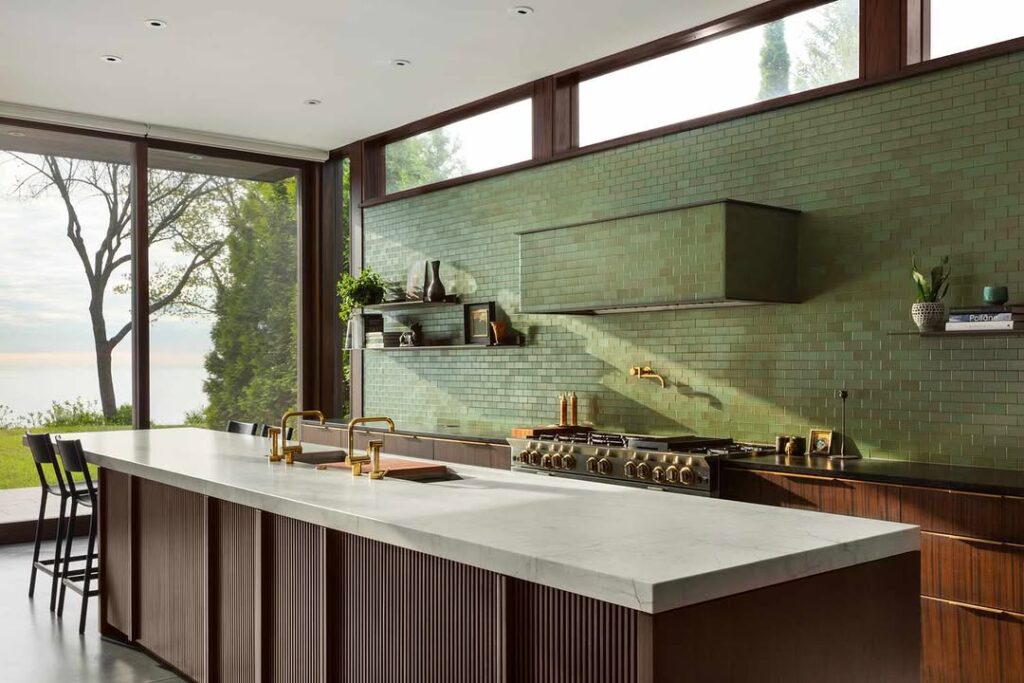 Modern kitchen with green tile wall and panoramic windows