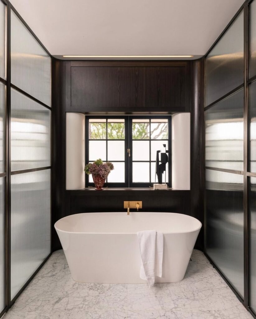 Modern bathroom with black walls and white freestanding tub