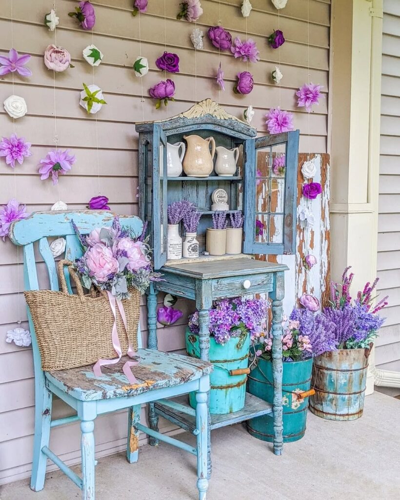 : Rustic blue furniture display with purple flowers and vintage garden decor