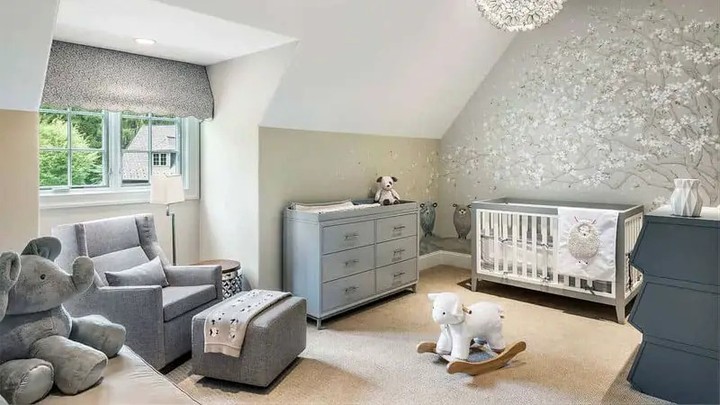 Gray nursery with silver wall decals crystal chandelier and matching furniture