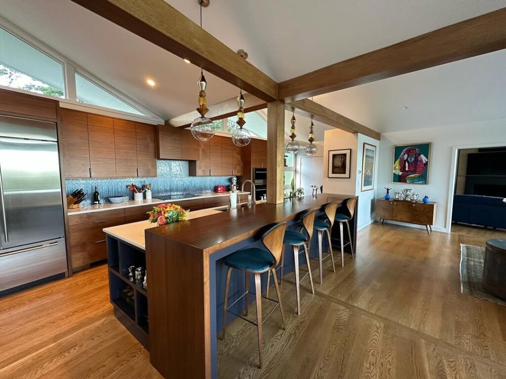 Kitchen featuring exposed beams and walnut cabinets