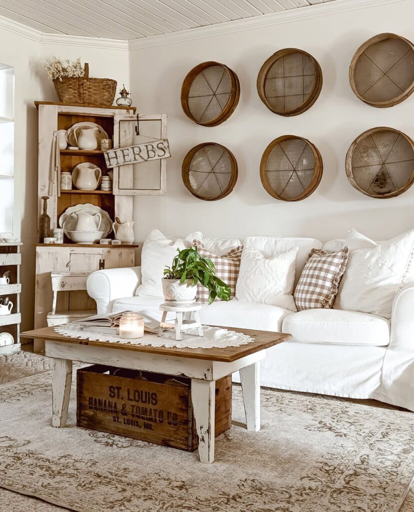 White farmhouse living room with wooden sieve wall decor and vintage furniture