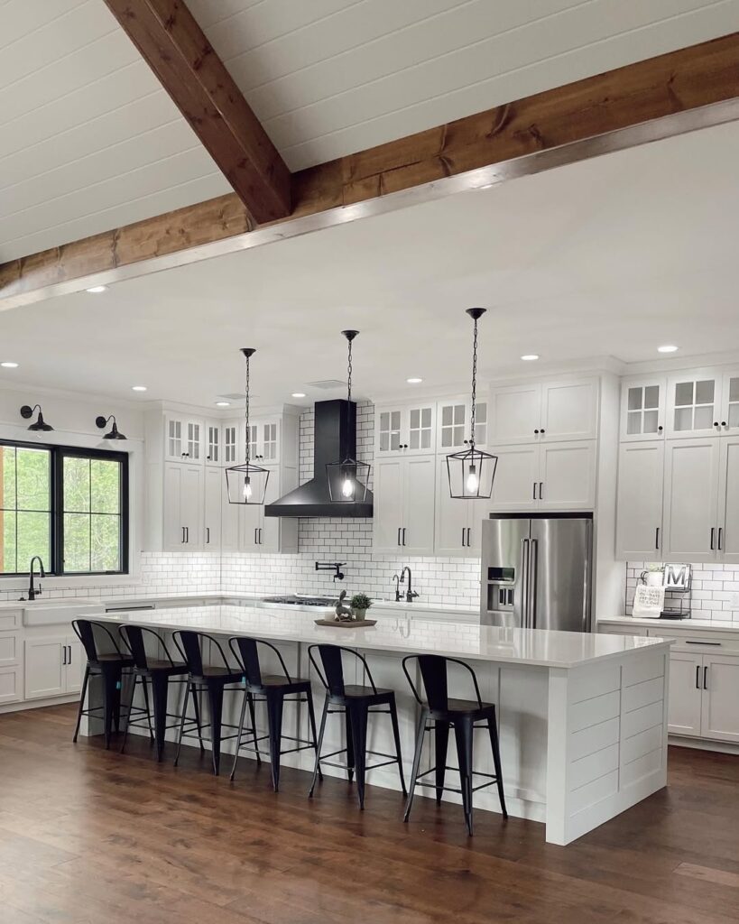 White kitchen with black hood wooden beams and lantern lights