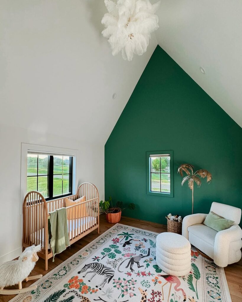  Nursery with green accent wall wooden crib and tropical animal print rug