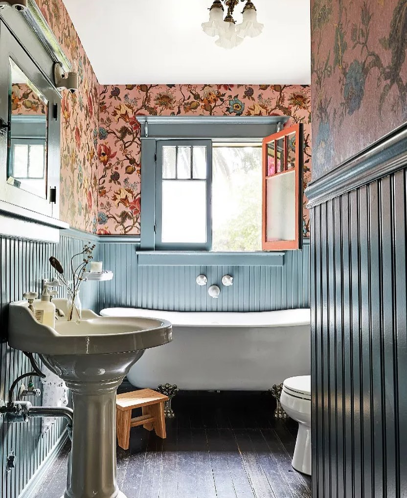 Cottage bathroom with blue beadboard and floral wallpaper